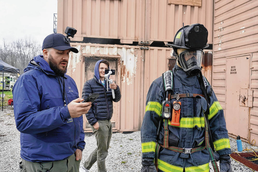 A firefighter is filmed in an outdoor location.